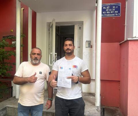 Operator Compania DDD la intrarea unui bloc, cu procesul-verbal semnat de reprezentantul asociației